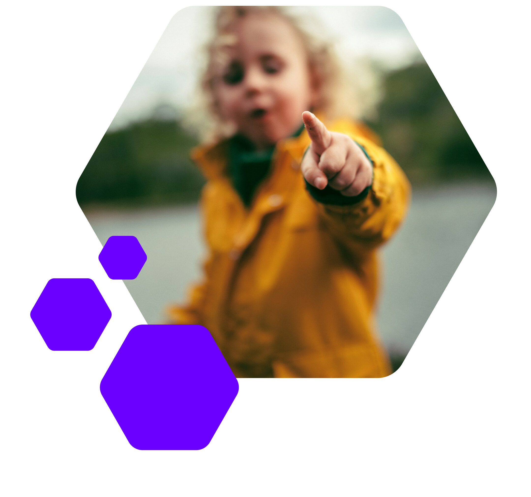 A child pointing with their finger towards the viewer, focus on his index finger; three purple hexagons in front of it