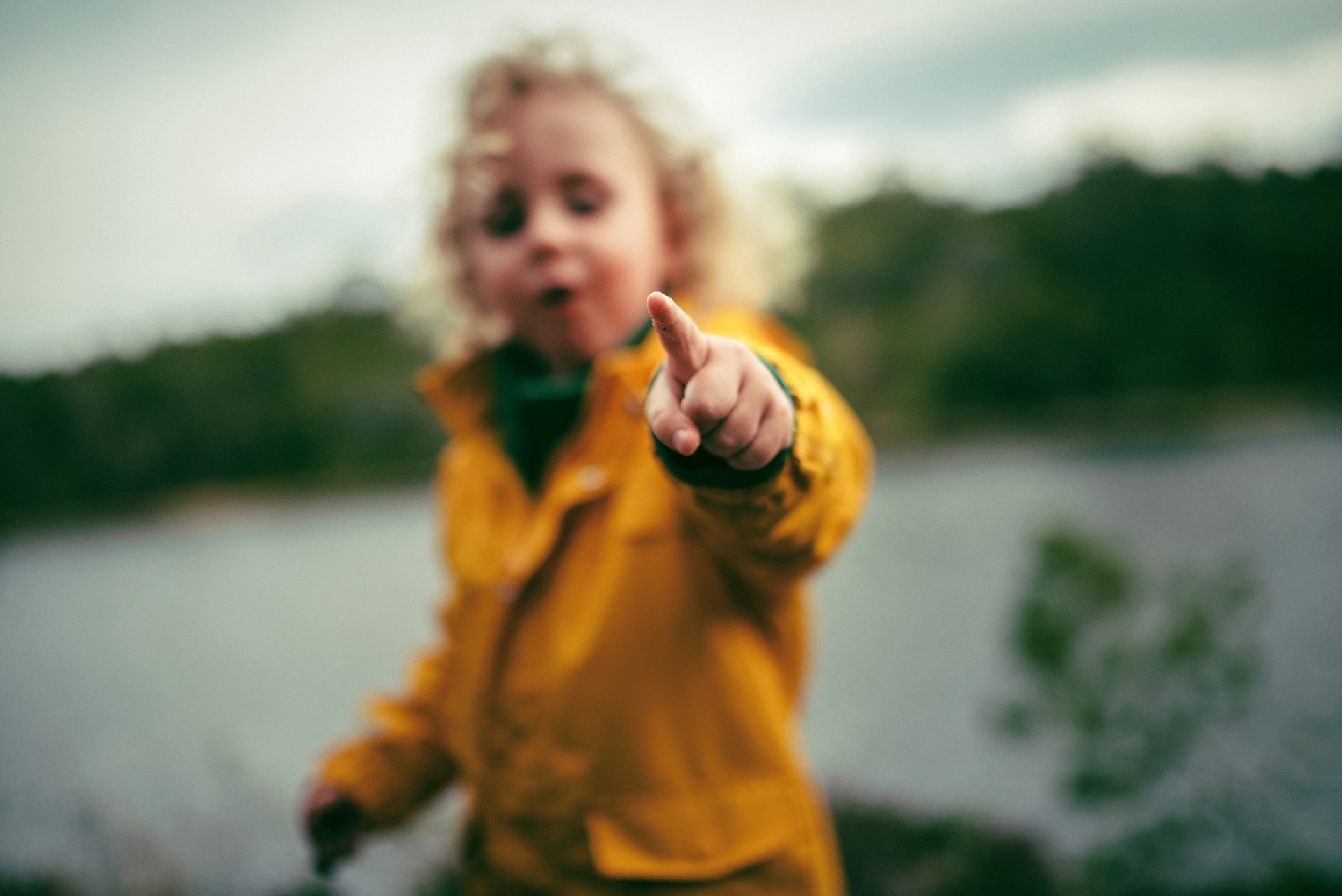 A child pointing with their finger towards the viewer